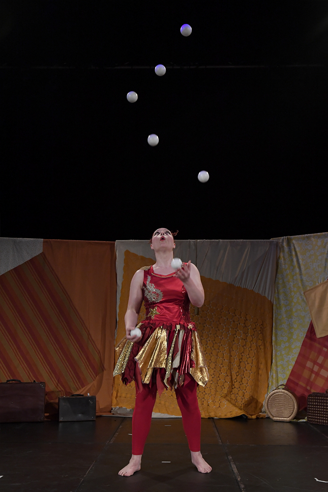 female juggling seven balls